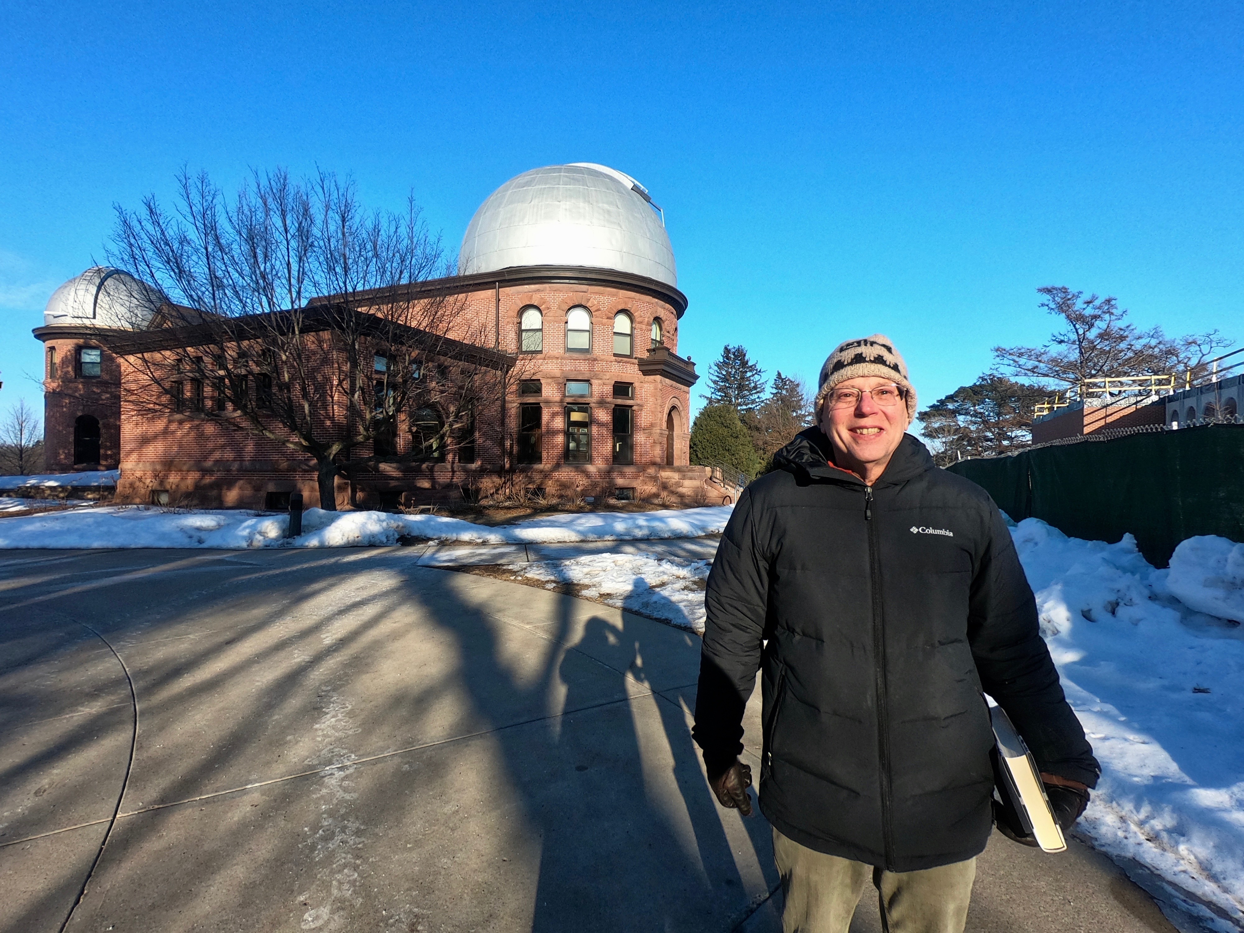 Photo of Joel outside Carleton's Goodsell Observatory