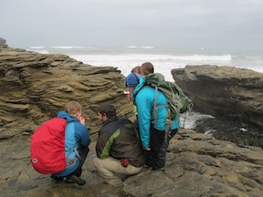 Discussing geology in the rain, Westport, New Zealand